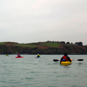 Group of paddlers near the lush green shores of Ireland