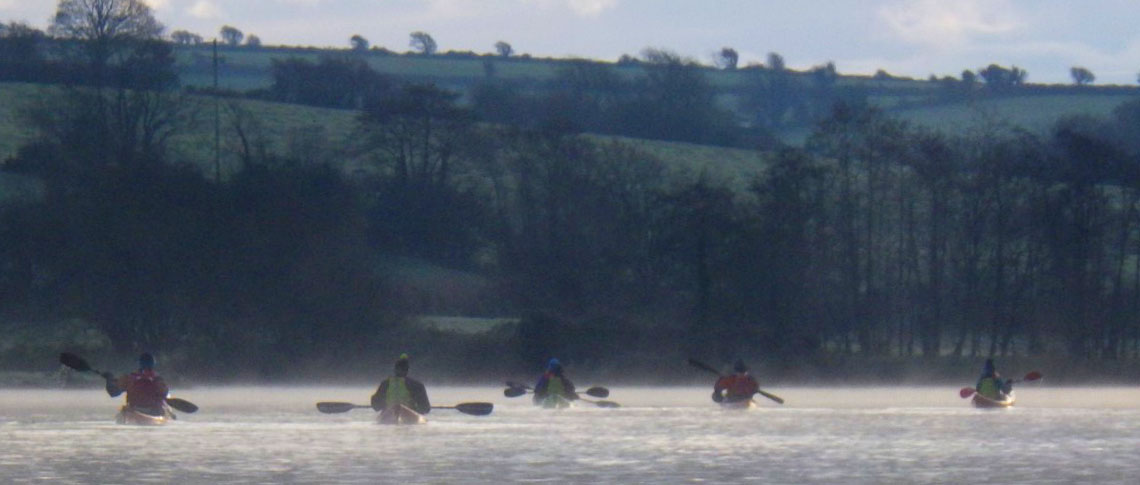 Group of kayakers along Ireland coast