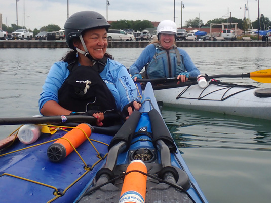 Two women kayaking in harbor