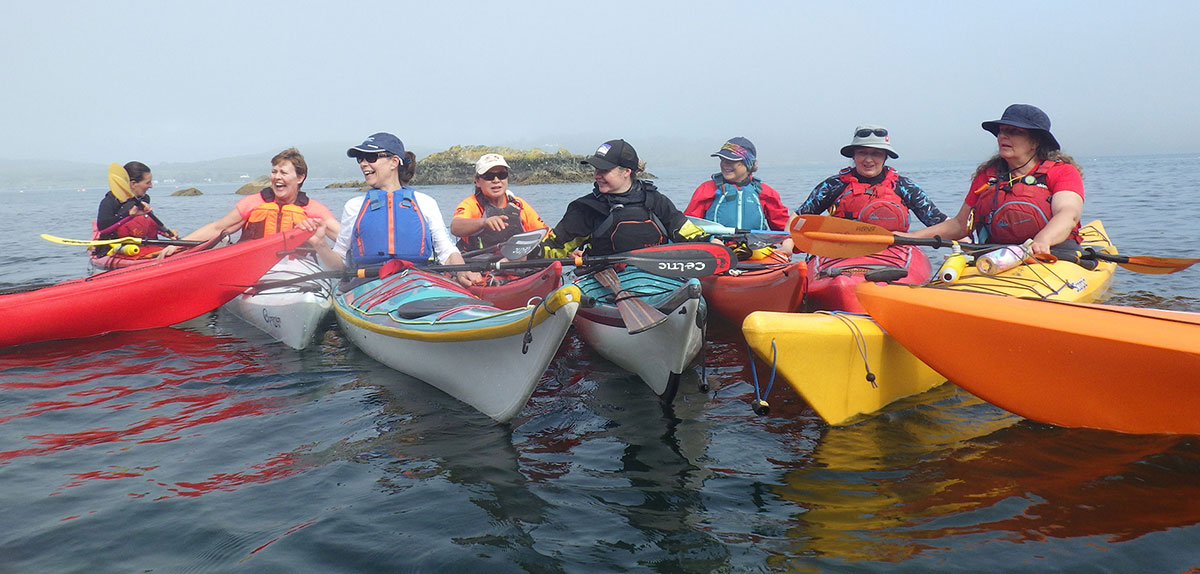 Large group of women kayakers